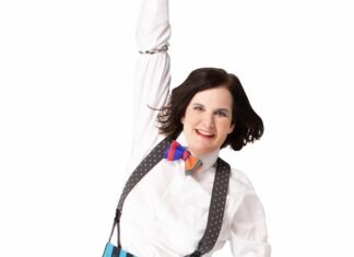 a woman with a bow tie and suspenders