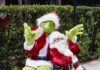 a man dressed as a santa clause sitting on top of a chair