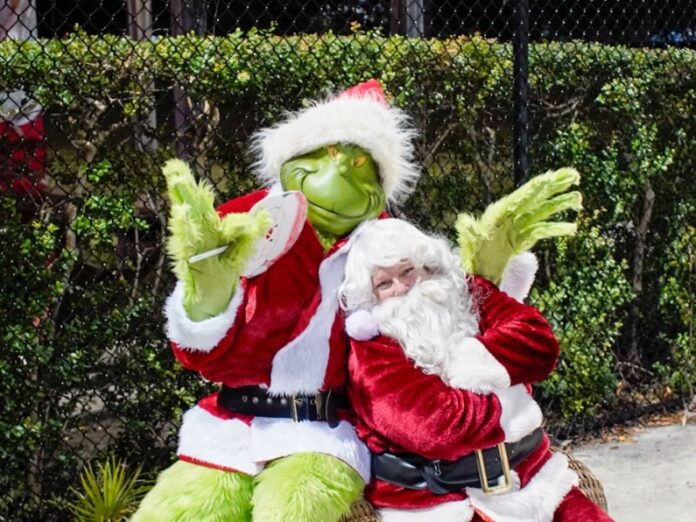 a man dressed as a santa clause sitting on top of a chair