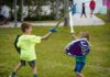 two young boys playing with a sword and shield