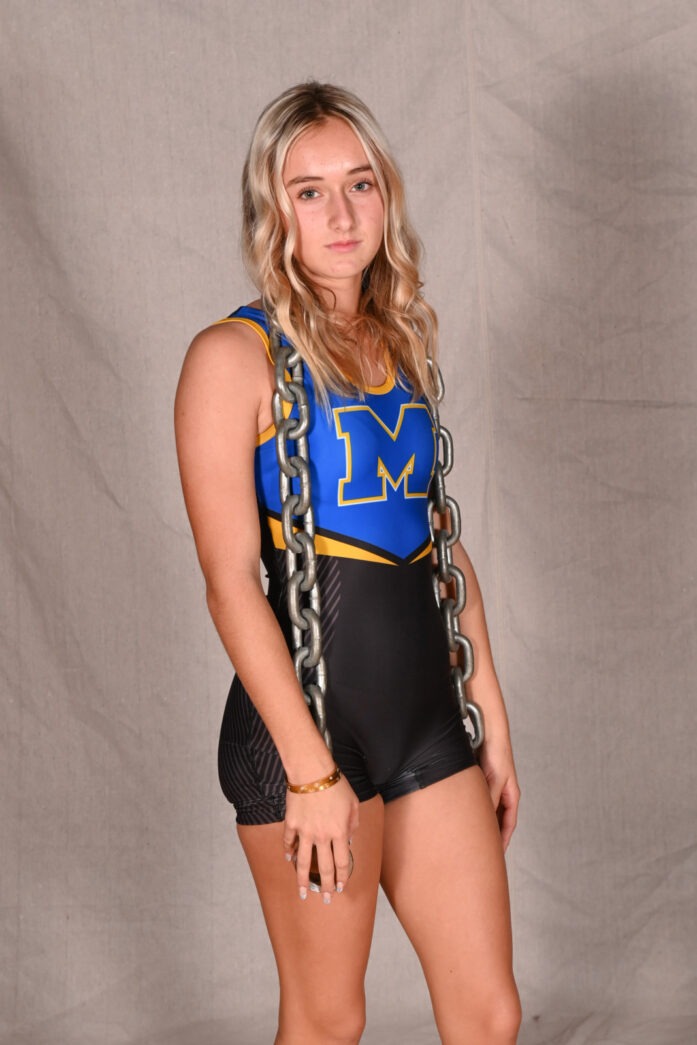 a woman in a blue and black wrestling suit