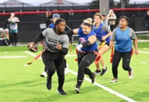 a group of women playing a game of frisbee