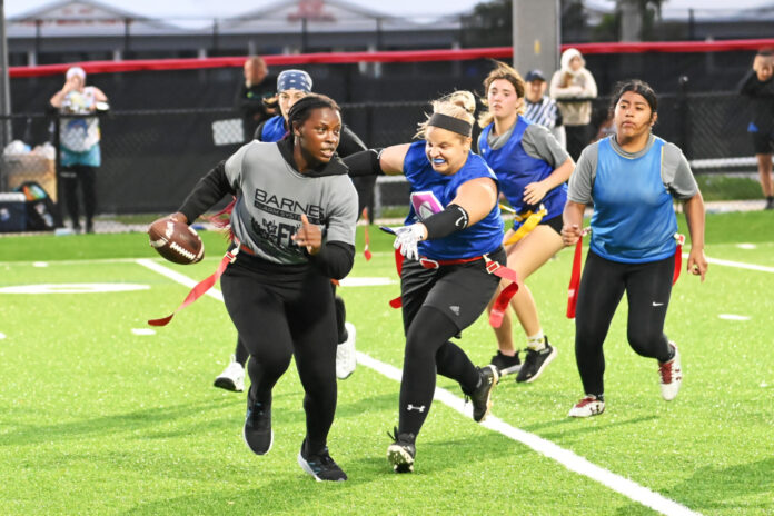 a group of women playing a game of frisbee