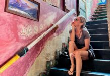 a woman sitting on the steps of a building