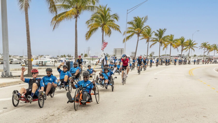 a group of people riding bikes down a street