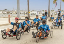 a group of men riding bikes down a street