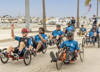 a group of men riding bikes down a street