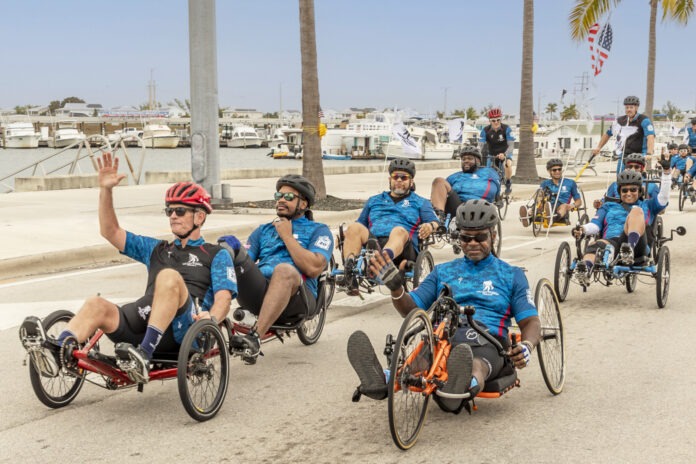 a group of men riding bikes down a street