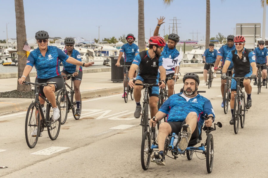 a group of people riding bikes down a street