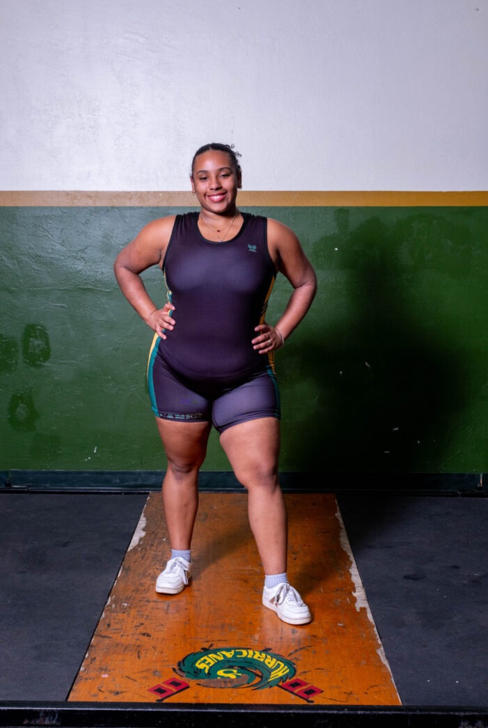 a woman standing on a platform in a gym