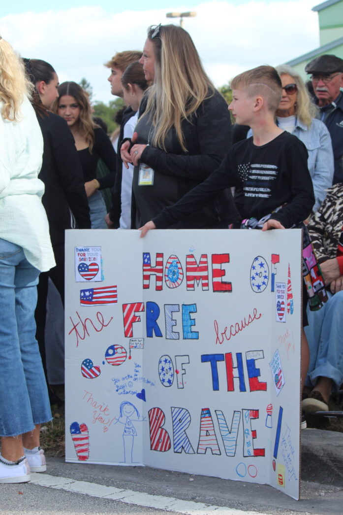 a group of people standing around a sign