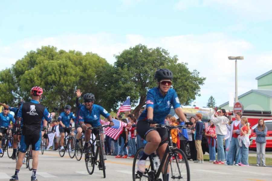 a group of people riding bikes down a street