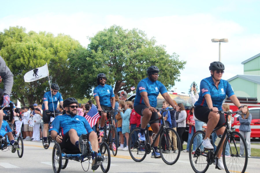 a group of people riding bikes down a street