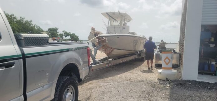 a truck with a boat on the back of it