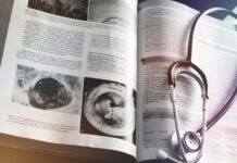 a medical book with a stethoscope on top of it