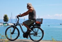 a man riding a bike next to a body of water