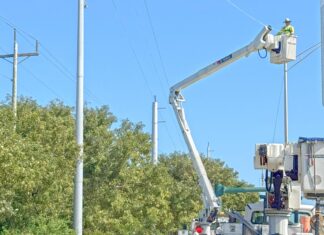 a couple of men working on a utility truck