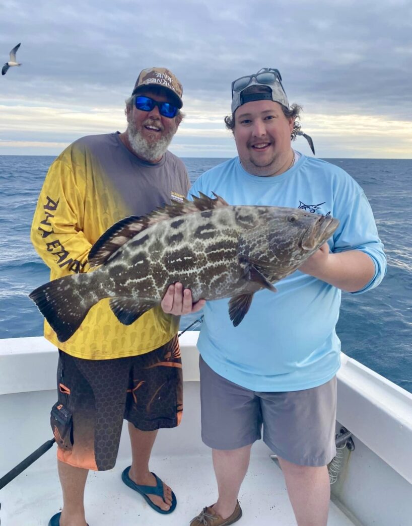 a couple of people on a boat with a fish