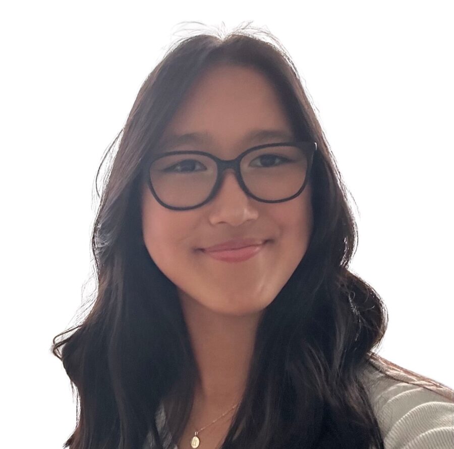 a woman with glasses smiling for the camera