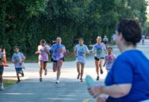 a group of people running down a street