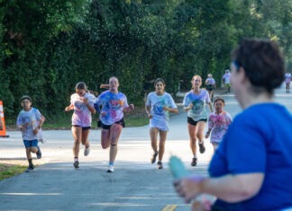 a group of people running down a street