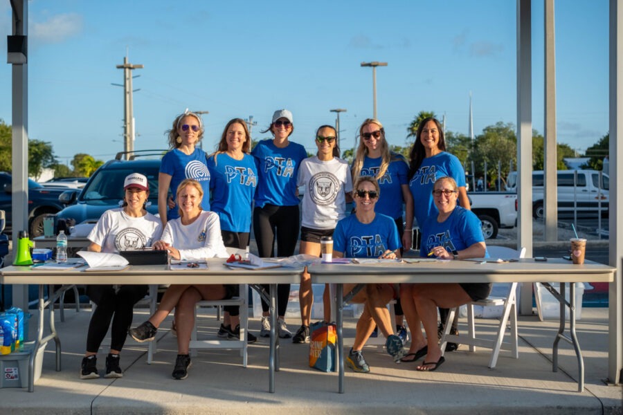 a group of people standing around a table