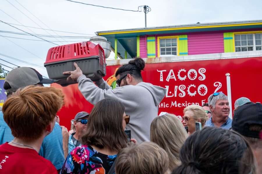 a group of people standing in front of a red truck