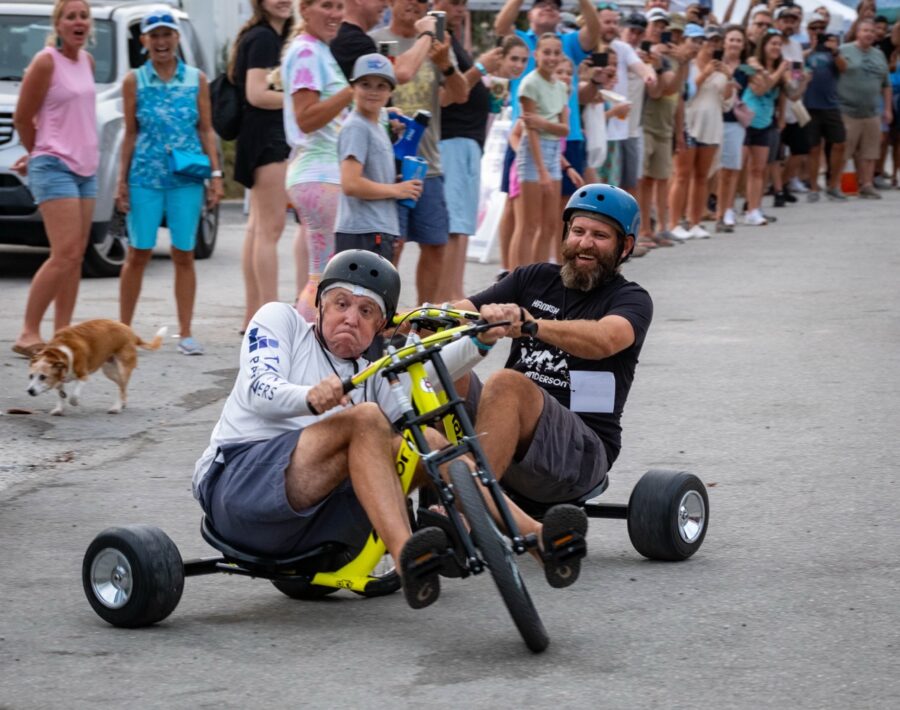 a man on a bike being pushed by another man