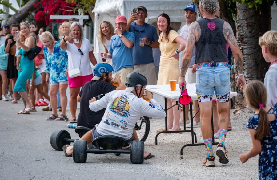 a group of people standing around a man on a skateboard