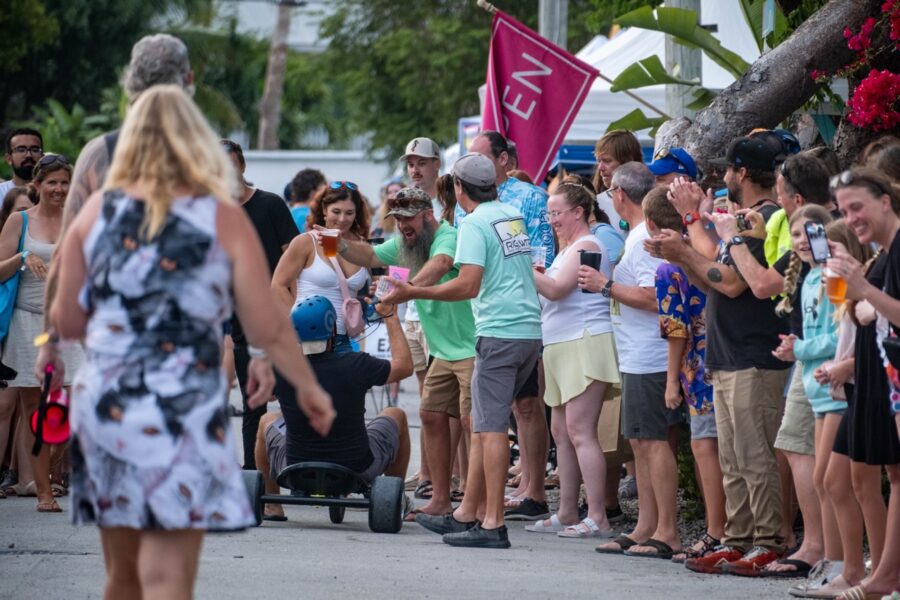 a crowd of people standing on the side of a road