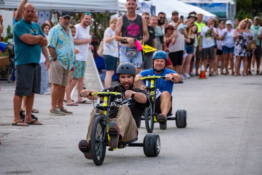 a group of people watching a man in a wheel chair