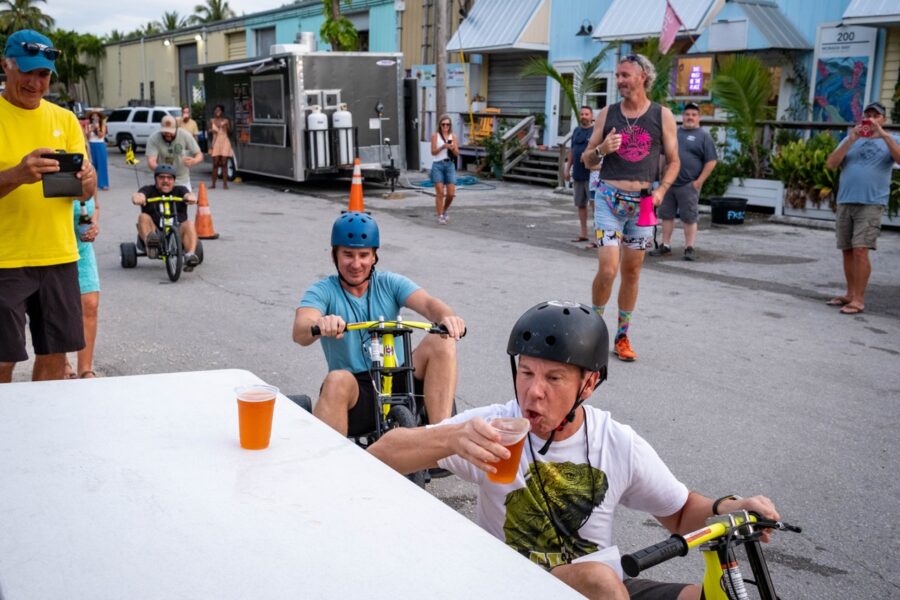 a group of people riding bikes down a street