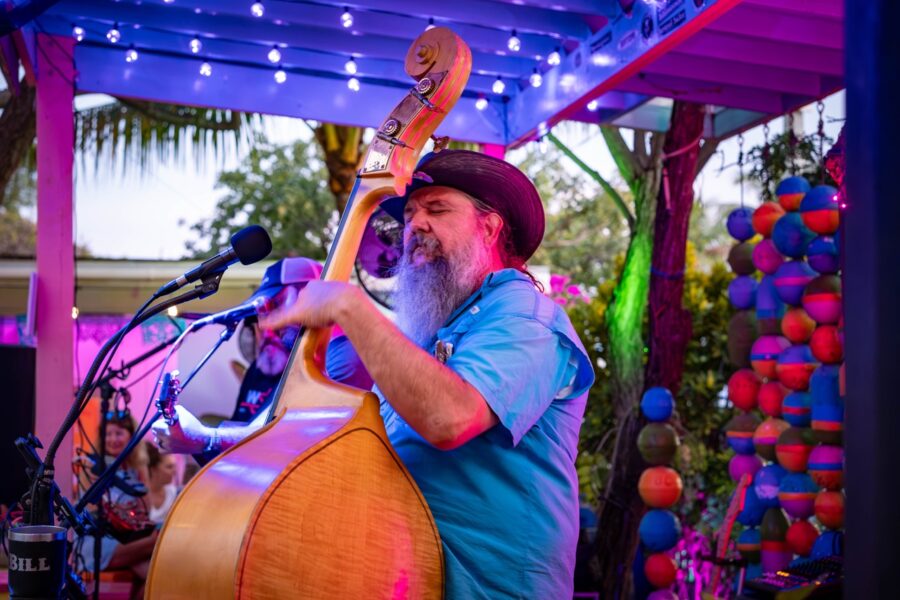 a man with a beard playing a guitar