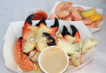 a plate of crab legs with dipping sauce