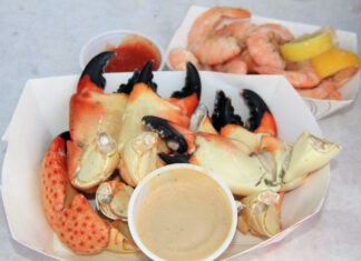 a plate of crab legs with dipping sauce