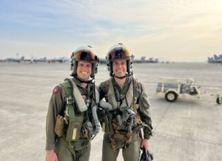 two women in military gear posing for a picture