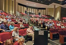 a large group of people sitting in a lecture hall