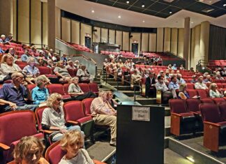 a large group of people sitting in a lecture hall