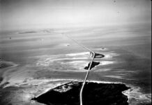 a black and white photo of an aerial view of a road