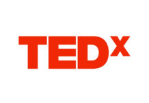 a red tedx logo on a white background