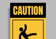 a yellow caution sign with a black and yellow image of a person falling