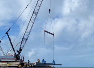 a crane on a boat in the ocean