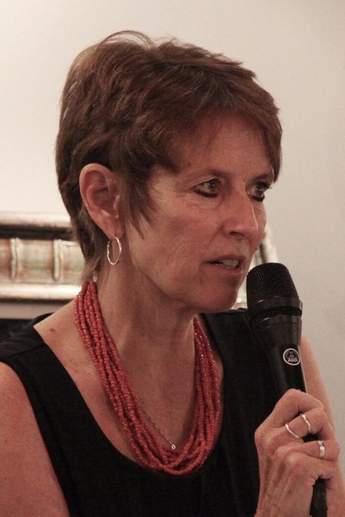 a woman in a black dress holding a microphone