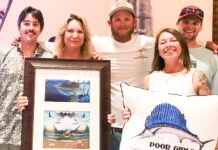 a group of people posing for a picture with a pillow