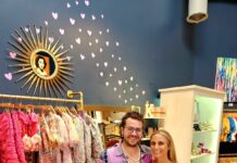 a man and a woman standing in a clothing store