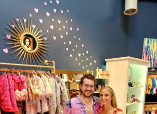 a man and a woman standing in a clothing store