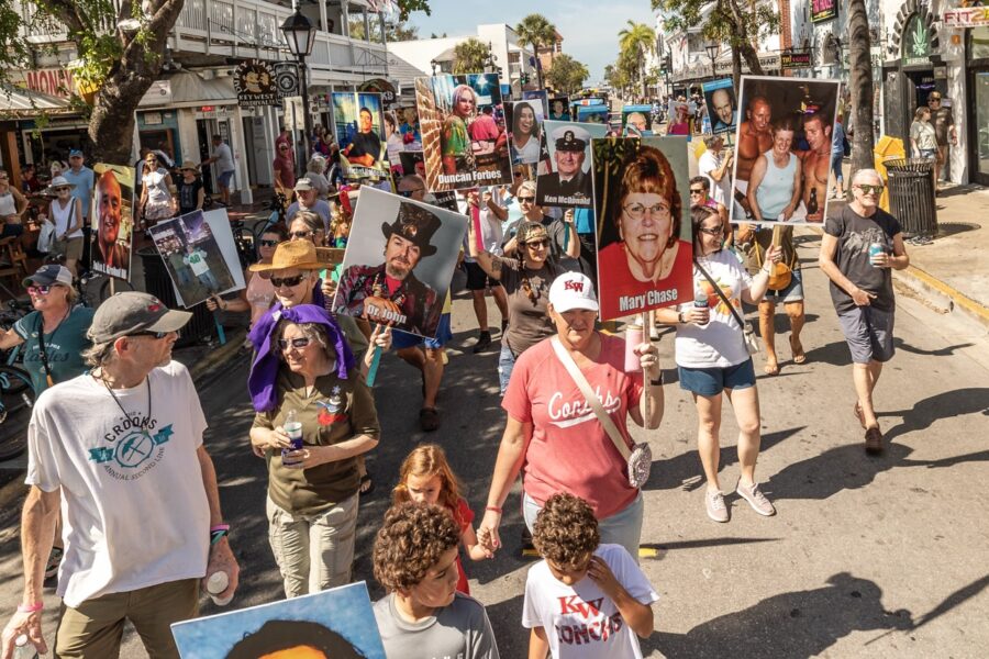 a crowd of people walking down a street