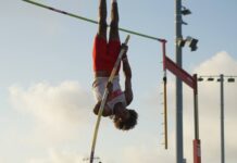 a person doing a high jump on a pole