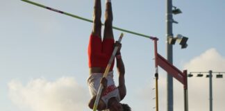 a person doing a high jump on a pole