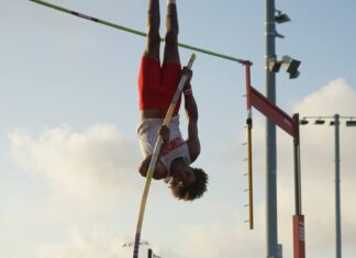 a person doing a high jump on a pole